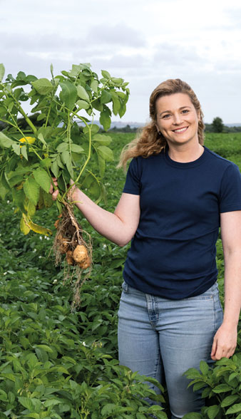Woman holding potato plant